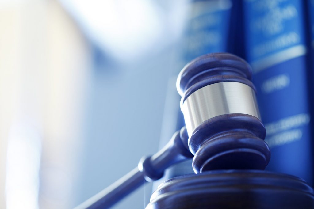 Gavel In Front Of Row Of Law Books