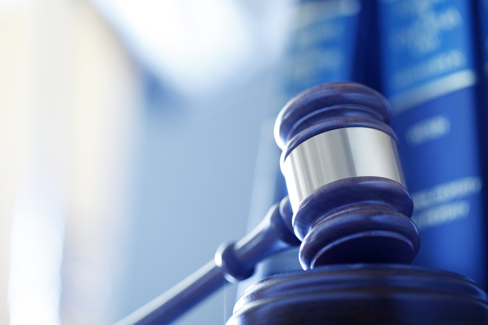 Gavel In Front Of Row Of Law Books